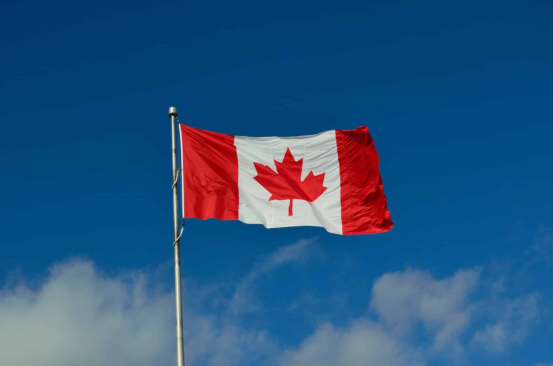 The Canadian flag waving in the air