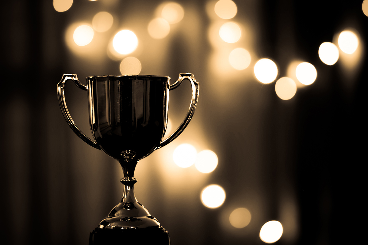 Award trophy and fairy light background
