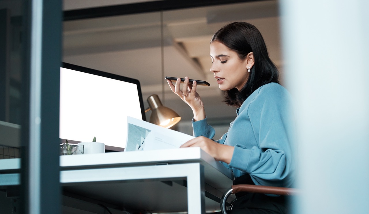 Billing team member speaking into a phone at her desk