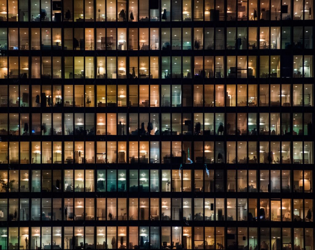 Dense grid of lit office building windows at night