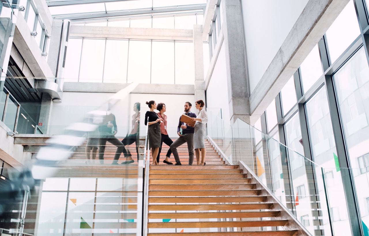 Colleagues talking in a bright modern office