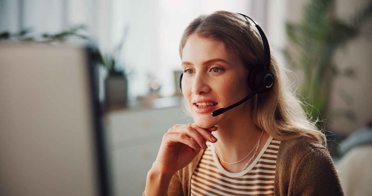 Support agent wearing a headset speaking with a caller