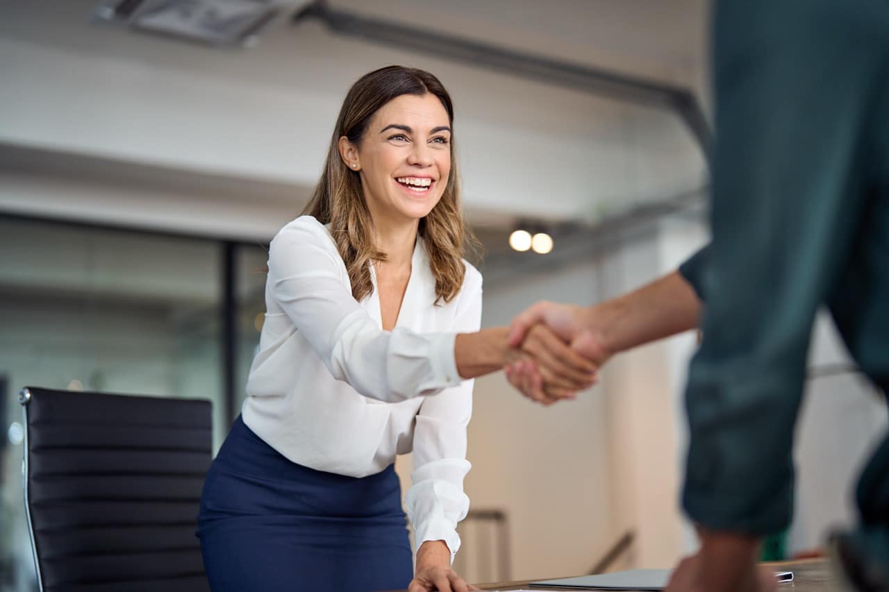 Two people shaking hands in an office