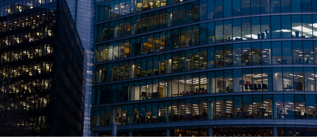 Illuminated glass office towers at night